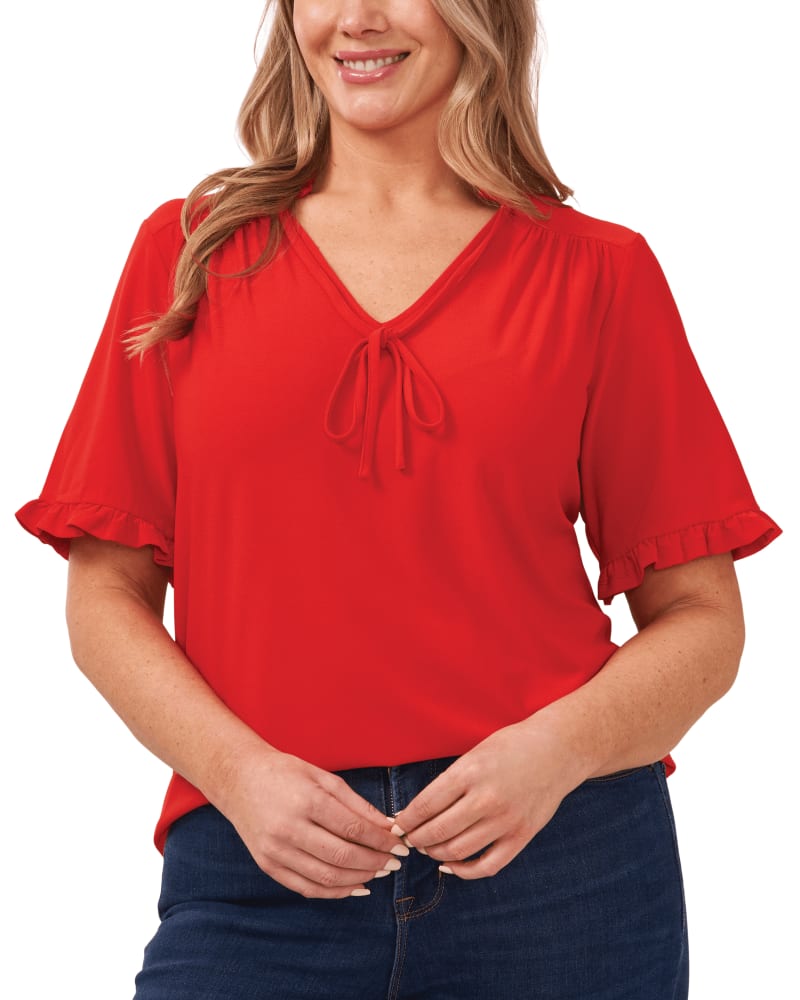 Front of a model wearing a size 1X Willa Ruffled Knit Top in FIREBALL by CeCe. | dia_product_style_image_id:263606